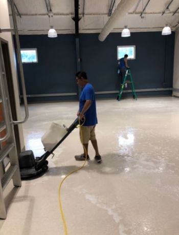 All Bright Cleaning Services janitor in New Castle, DE mopping floor.